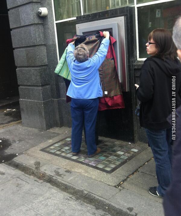 Funny Pictures - Woman protecting her husbands password at ATM machine