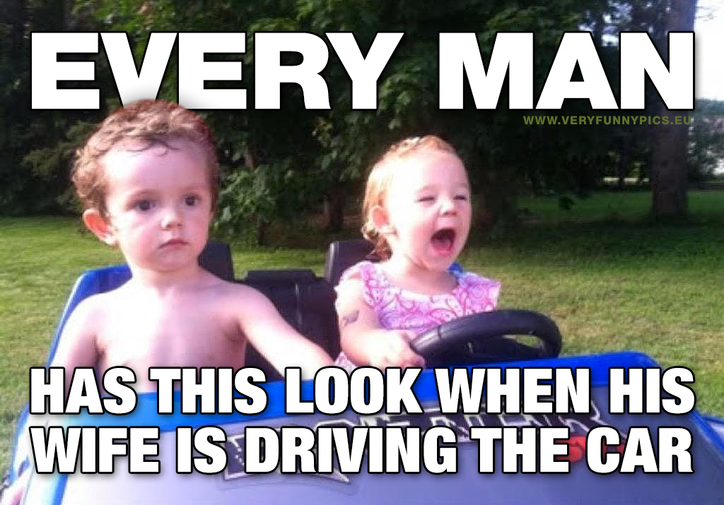 Boy next to a girl in a toy car - Every man has this look when his wife is driving the car