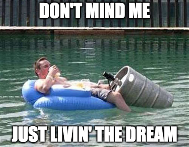 Man floating and drinking beer - Don't mind me, just living the dream