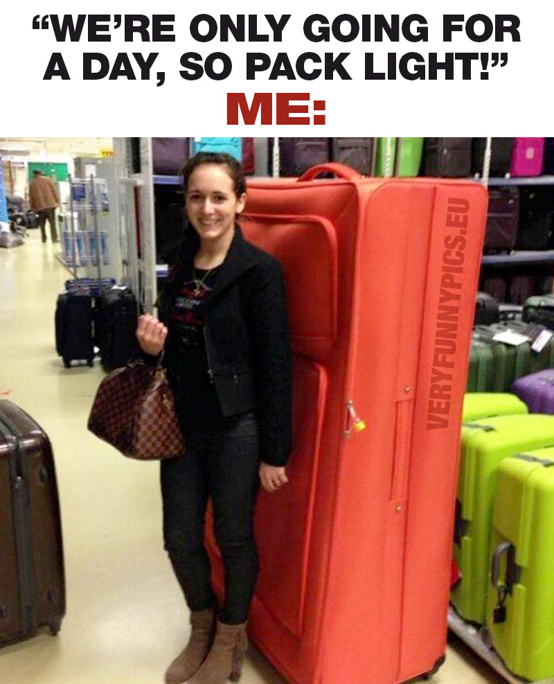 Woman in front of huge suitcase